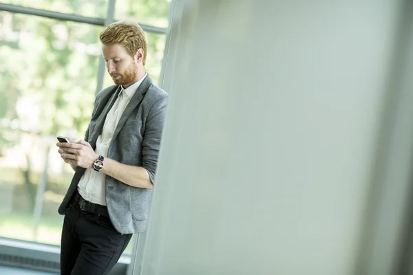 Young man with mobile phone — Stock Photo, Image