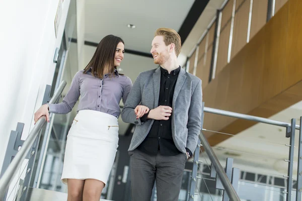 Young couple on the stairs in office