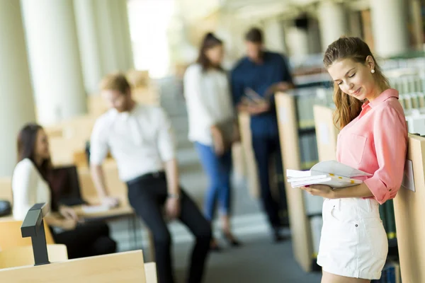 Young woman in the library — Stock Photo, Image