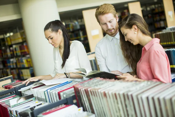 Students with book in the library — Stock Photo, Image