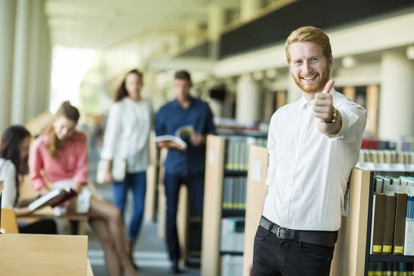 Young man in the library — Stock Photo, Image