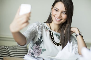 Genç bir kadın selfie çekiyor.