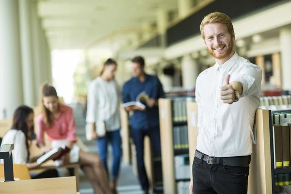 Young man in the library — Stock Photo, Image