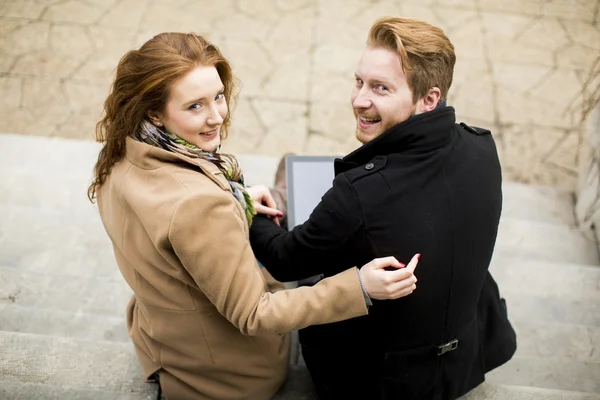 Young couple with tablet — Stock Photo, Image