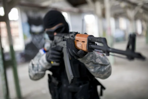 Armed man in uniform — Stock Photo, Image