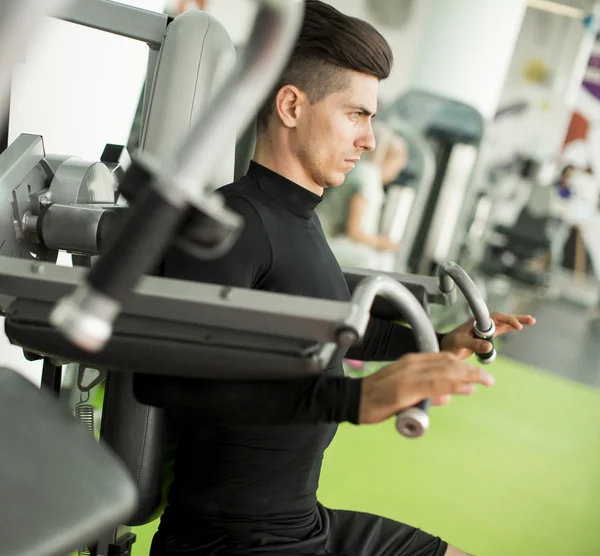 Young man in the gym — Stock Photo, Image