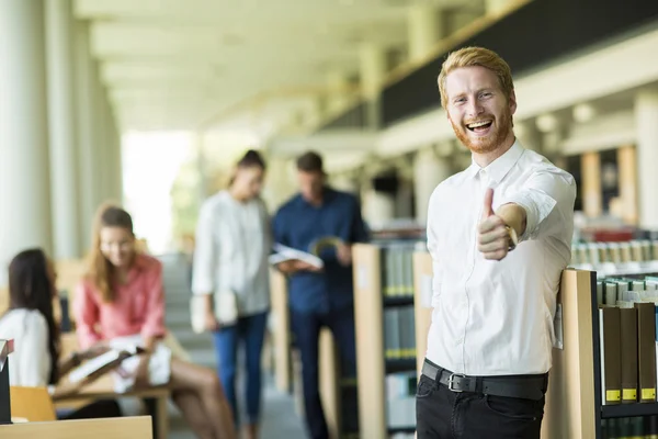 Young man in the library — Stock Photo, Image