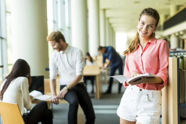 Young woman in the library — Stock Photo, Image