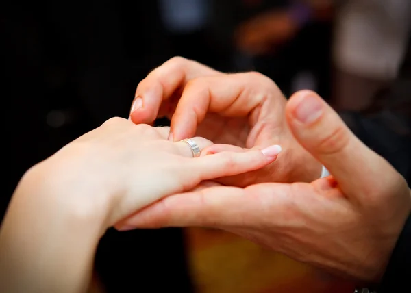 Casal colocando alianças de casamento — Fotografia de Stock