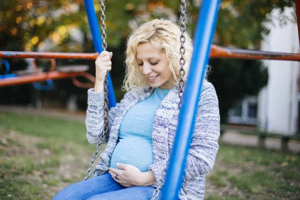 Femme enceinte sur le swing — Photo