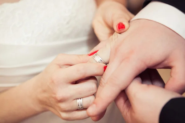 Couple putting wedding rings — Stock Photo, Image