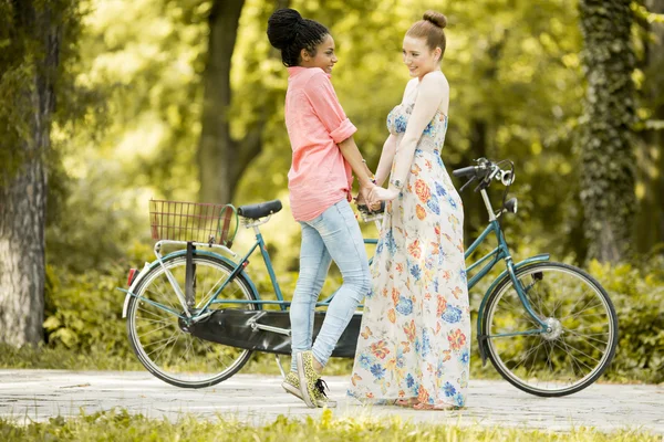 Young women with bicycle — Stock Photo, Image