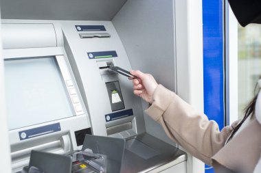 Woman using the ATM clipart