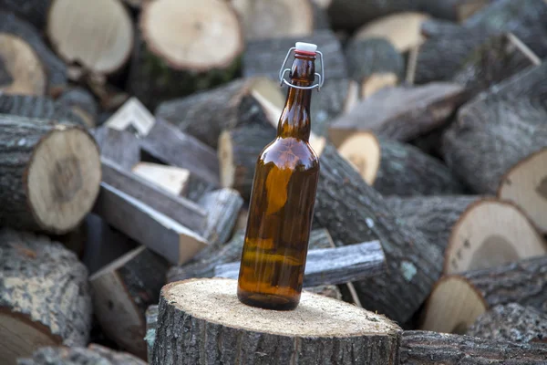 Glass bottle on stack — Stock Photo, Image