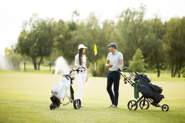Young couple at golf cart — Stock Photo, Image