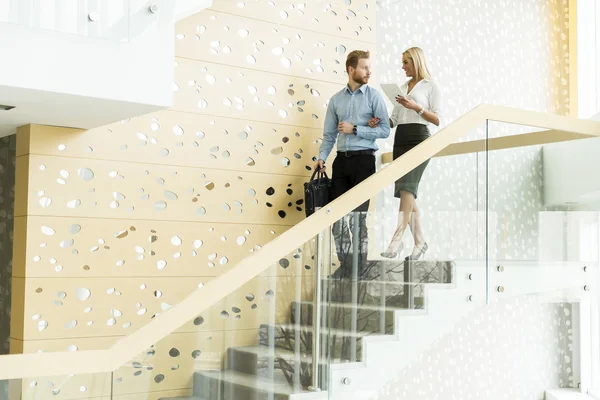 Couple on stairs in the office — Stock Photo, Image