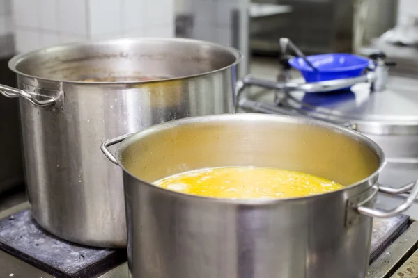 Pots with soup on the stove — Stock Photo, Image