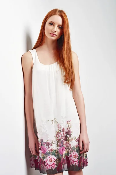 Beautiful female in sleeveless flower print summer dress — Stock Photo, Image