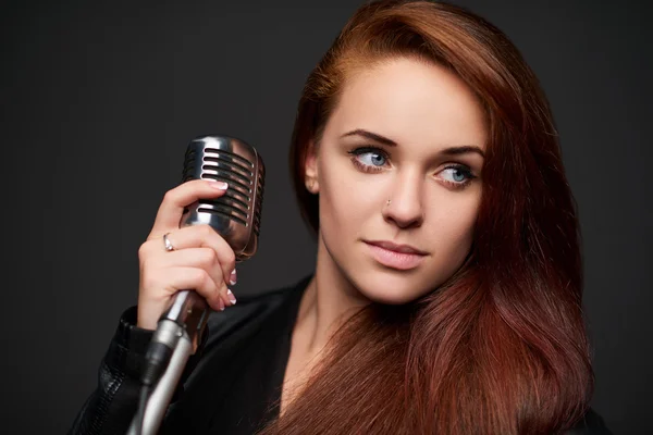 Closeup of young woman with retro microphone — Stock Photo, Image
