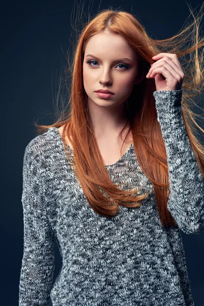 Beautiful red haired female in grey sweater — Stock Photo, Image