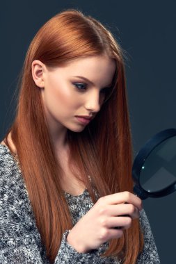 Woman looking through magnifying glass clipart
