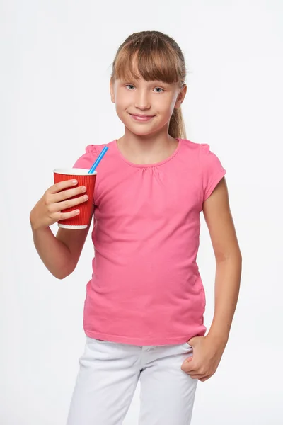 Little child girl holding a drink in disposable paper cup — Stock Photo, Image