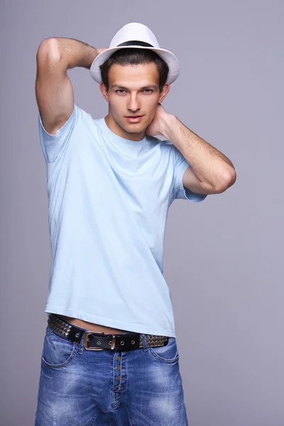 Man standing posing with hat — Stock Photo, Image