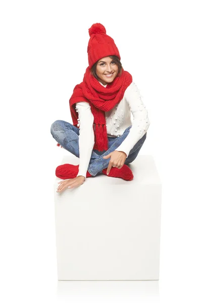 Winter woman sitting on blank billboard placard sign — Stock Photo, Image