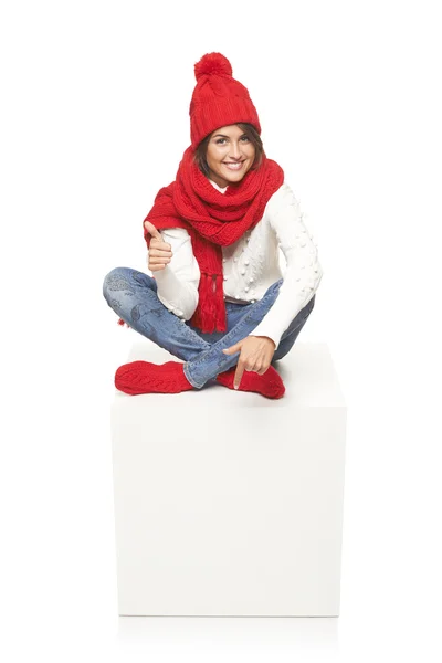 Winter woman sitting on blank billboard placard sign — Stock Photo, Image