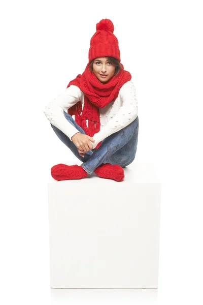 Winter woman sitting on blank billboard placard sign — Stock Photo, Image