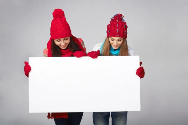 Two winter females with banner — Stock Photo, Image