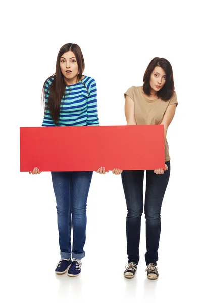 Two girl friends with red banner — Stock Photo, Image