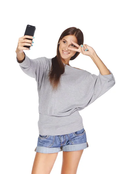 Female taking pictures of herself at smart phone — Stock Photo, Image