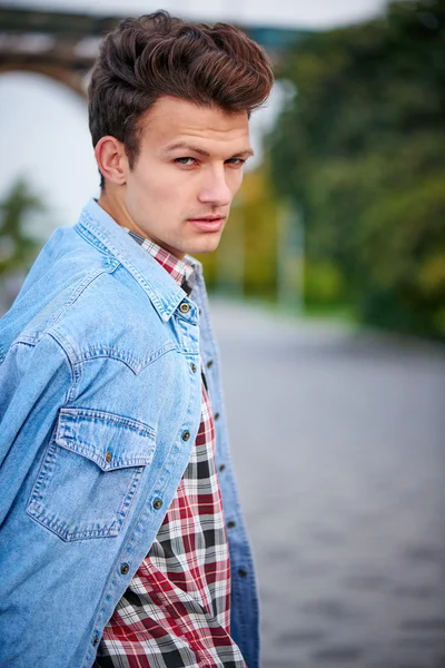 Handsome man outdoors over urban background — Stock Photo, Image