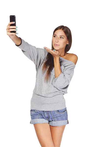 Female taking pictures of herself at smart phone — Stock Photo, Image