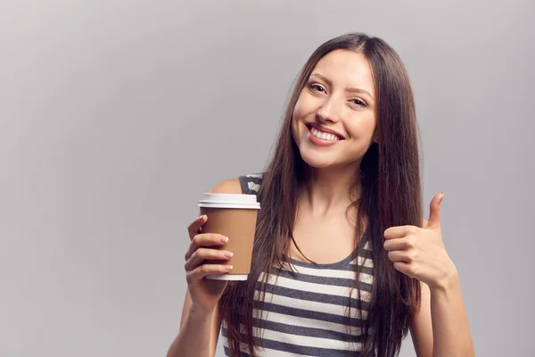 Woman drinking hot drink from disposable paper cup — Stock Photo, Image