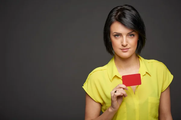 Mujer segura mostrando tarjeta de crédito en blanco — Foto de Stock