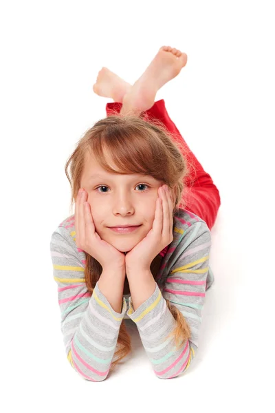 Front view of smiling child girl lying on stomach — Stock Photo, Image