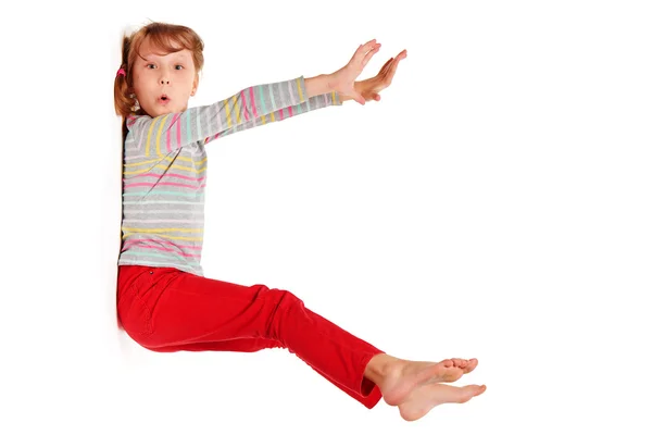 Funny image of amazed girl sticked to white wall — Stock Photo, Image