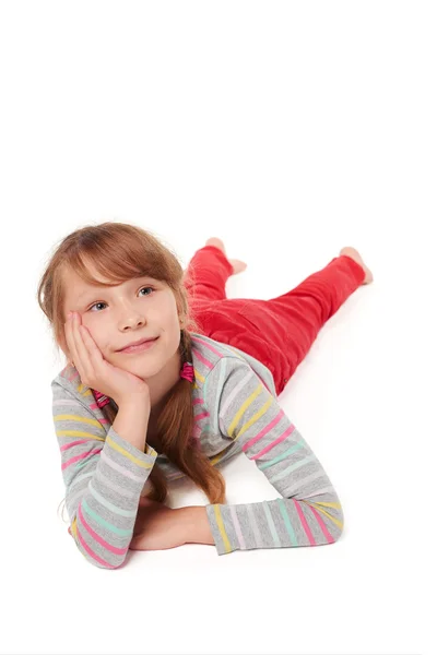 Smiling child girl lying on the floor — Zdjęcie stockowe