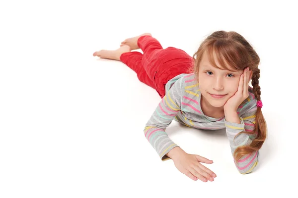 Front view of smiling child girl lying on floor — Stock Photo, Image