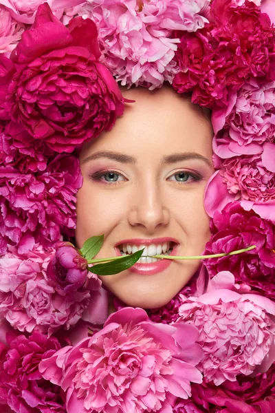 Woman face in peony flowers — Stock Photo, Image