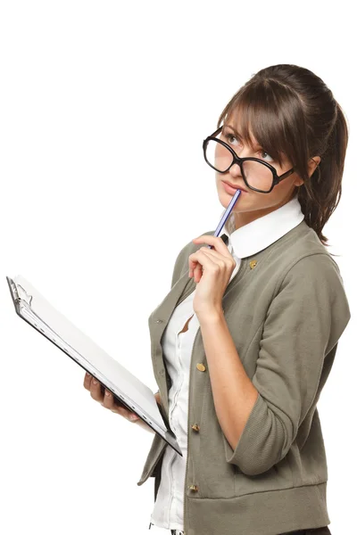 Pensive woman wearing old fashioned eyeglasses standing with clipboard and a pan — Stock Fotó