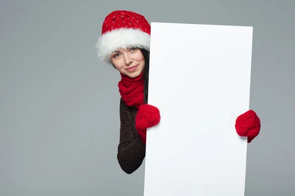 Woman in Santa hat holding white banner — Stockfoto