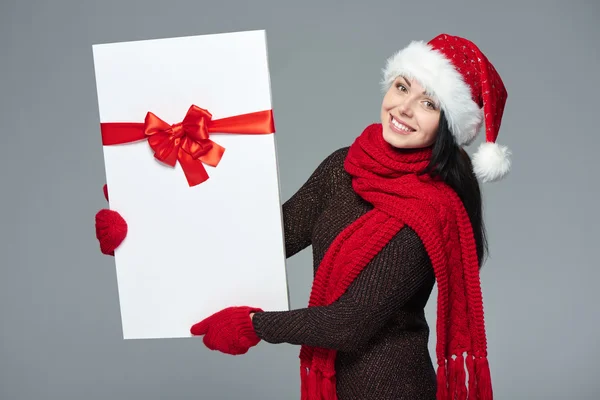 Woman in Santa hat holding white banner — Stock Photo, Image