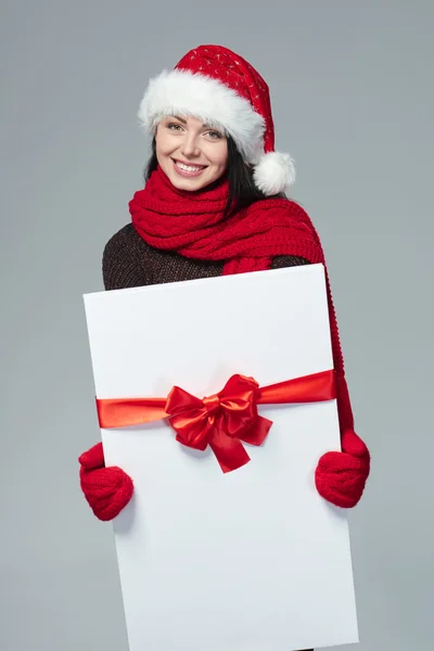 Woman in Santa hat holding white banner — 스톡 사진