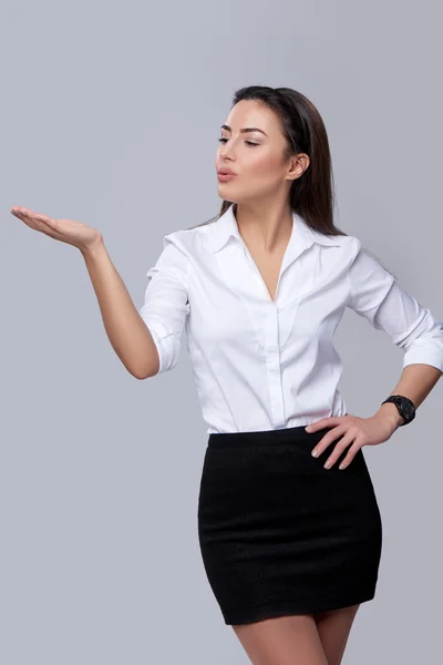 Business woman blowing on palm — Stock Photo, Image