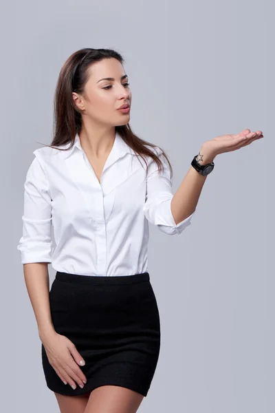 Business woman blowing on palm — Stock Photo, Image