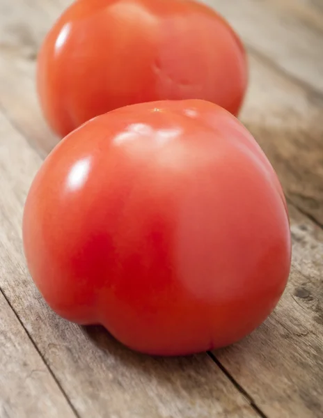 Tomato on wooden background — Stock Photo, Image