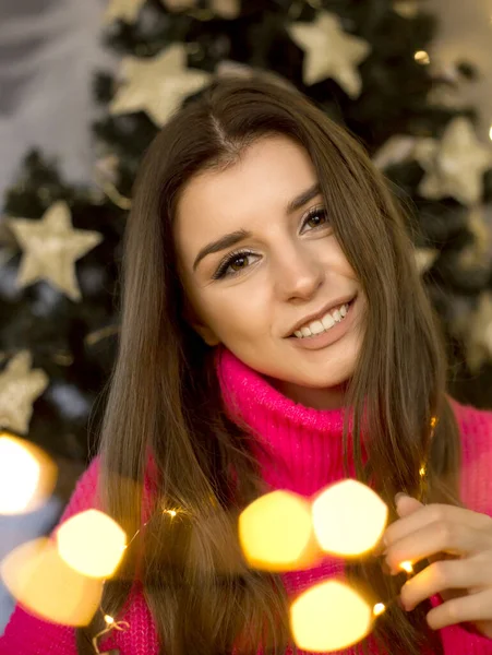 woman cozy christmas portrait with lights